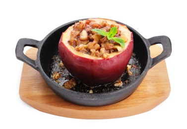 Tasty baked apple with nuts, honey and mint in baking dish isolated on white