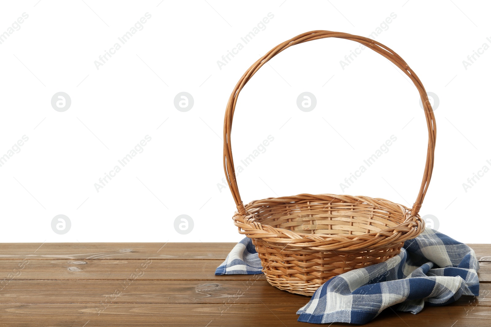 Photo of Wicker basket and towel on wooden table against white background, space for text. Easter item