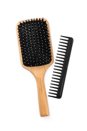 Photo of New wooden hair brush and comb isolated on white, top view