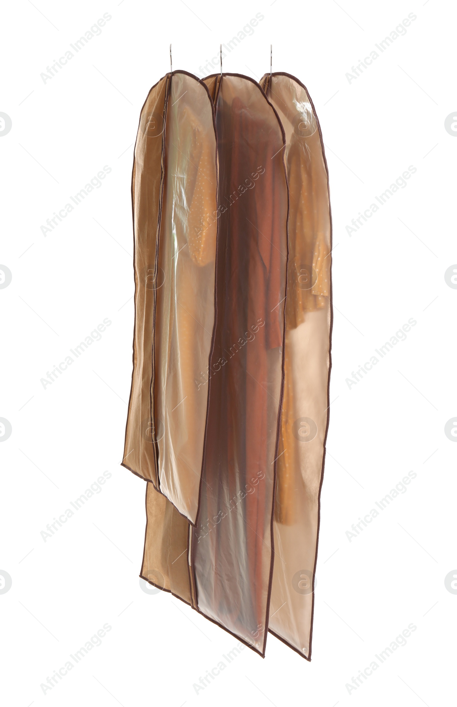 Photo of Garment bags with clothes on white background