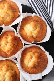 Photo of Delicious sweet muffins on grey table, flat lay