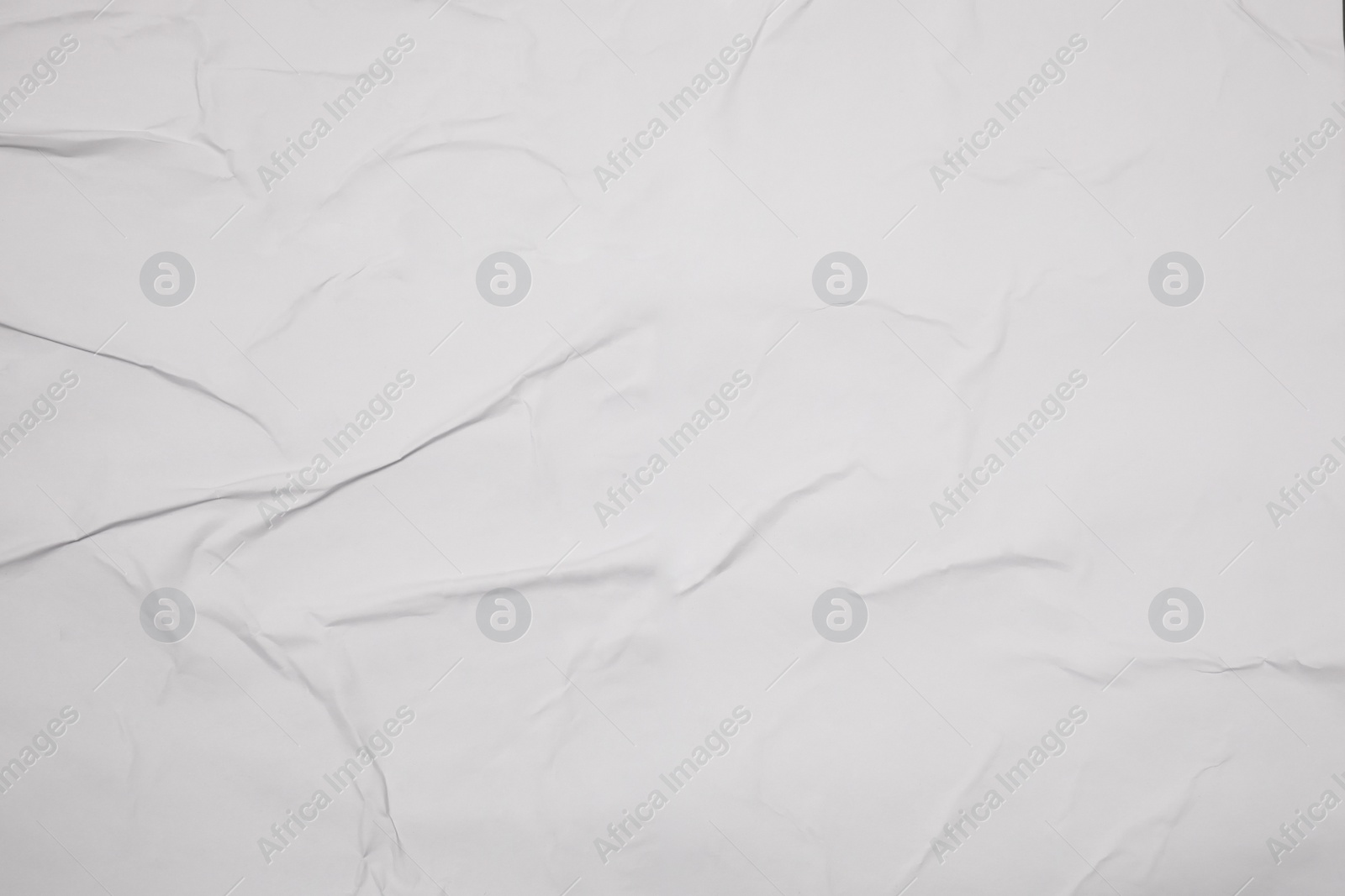 Photo of Top view of white creased blank poster as background, closeup