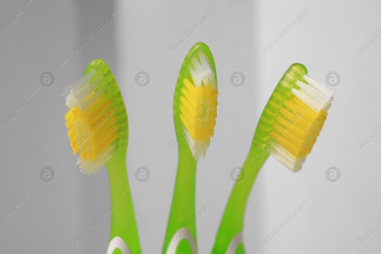 Photo of New toothbrushes on blurred background, closeup view