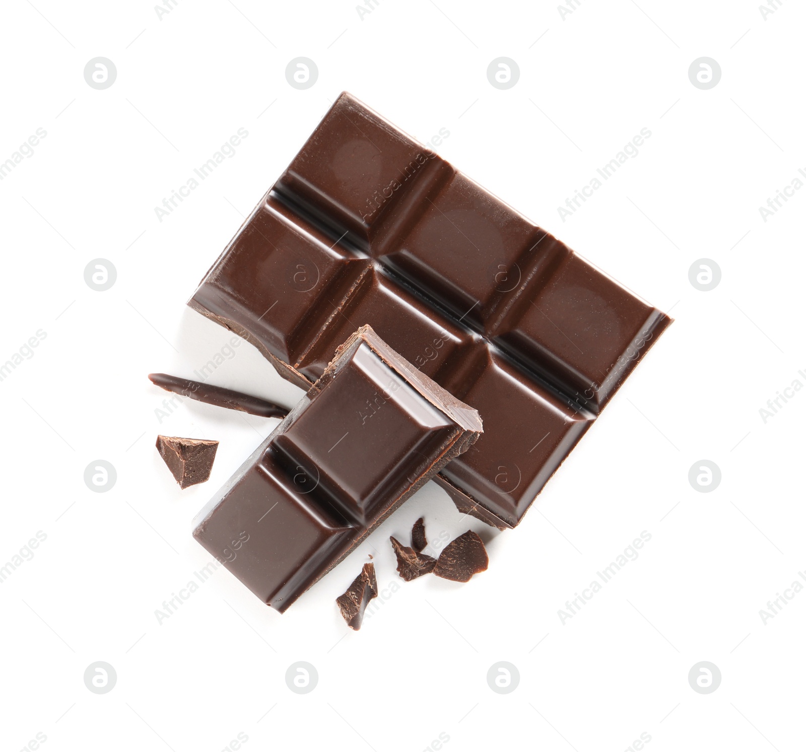 Photo of Pieces of tasty black chocolate on white background, top view