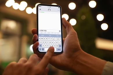 Image of Man sending message with text I Love You, closeup