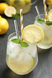 Photo of Natural lemonade with mint on grey table, closeup. Summer refreshing drink