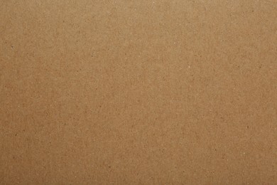 Photo of Kraft paper notebook sheet as background, top view