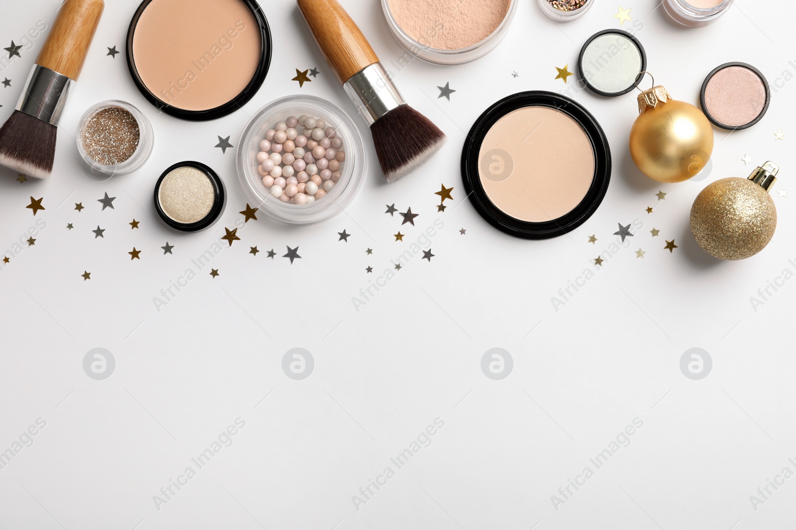 Photo of Flat lay composition with makeup products and Christmas decor on white background. Space for text