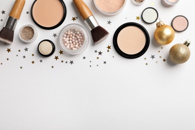 Photo of Flat lay composition with makeup products and Christmas decor on white background. Space for text