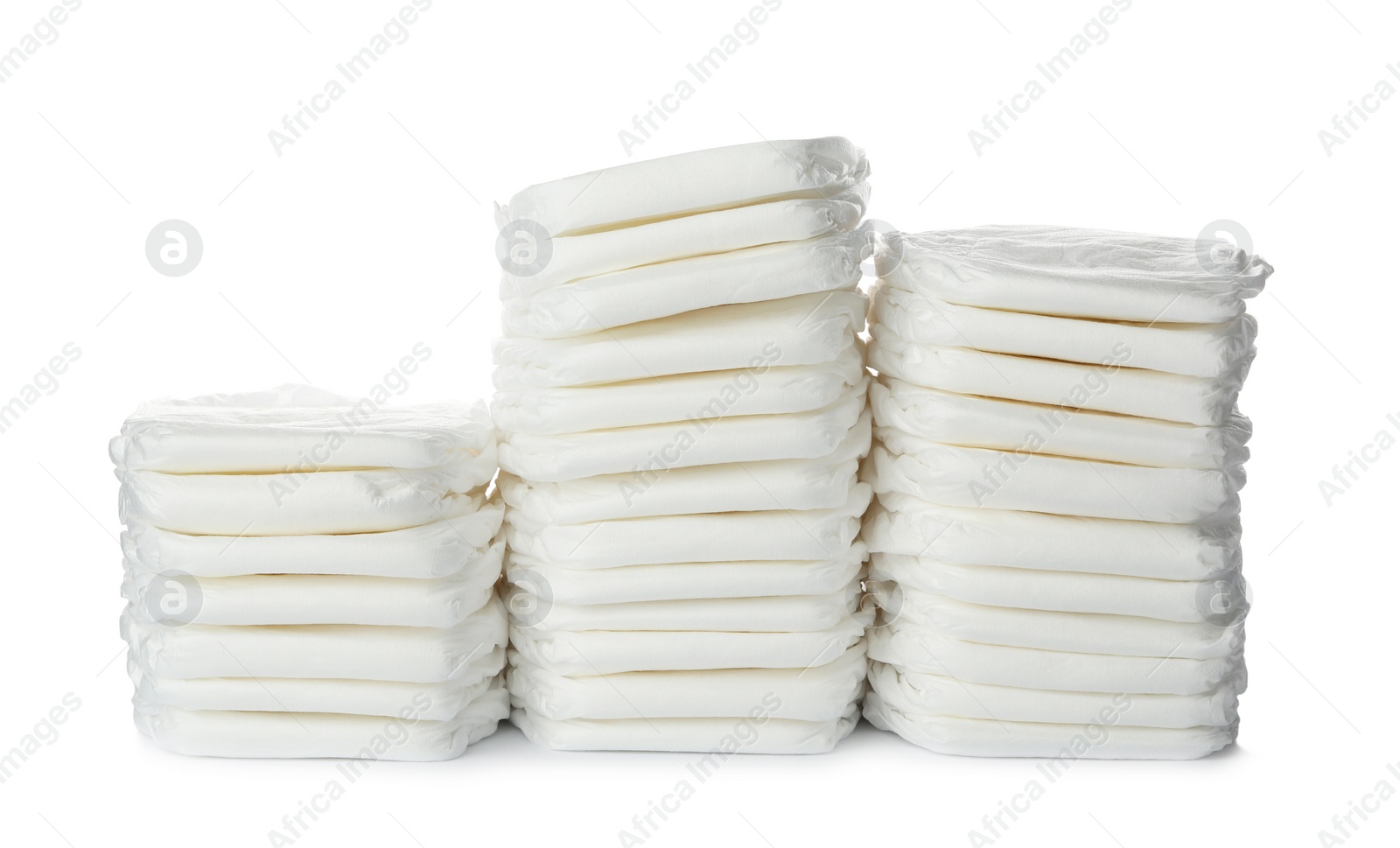 Photo of Stacks of baby diapers isolated on white