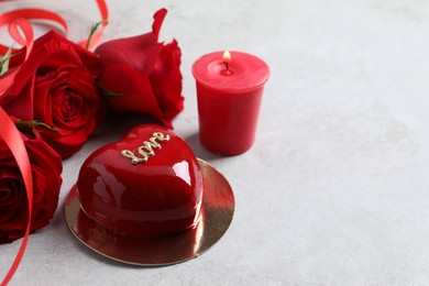 St. Valentine's Day. Delicious heart shaped cake, roses and candle on light table, closeup. Space for text