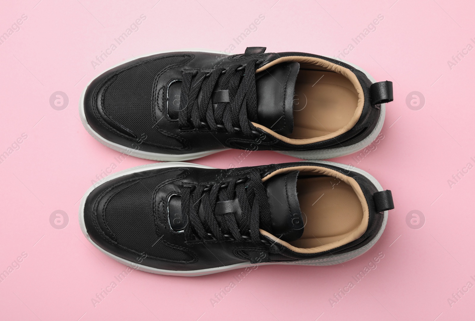 Photo of Pair of stylish shoes on pink background, top view