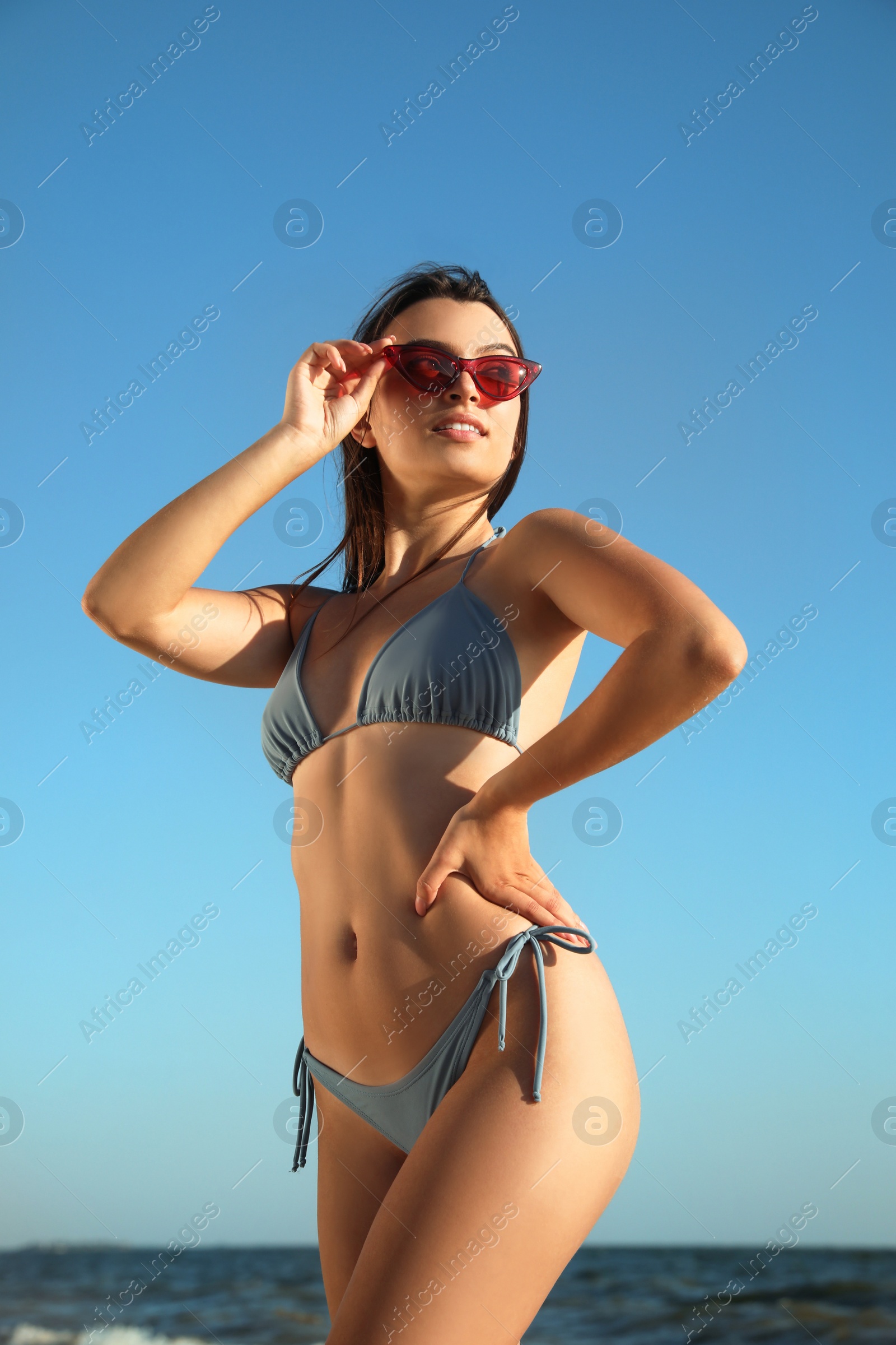 Photo of Beautiful young woman with attractive body on beach