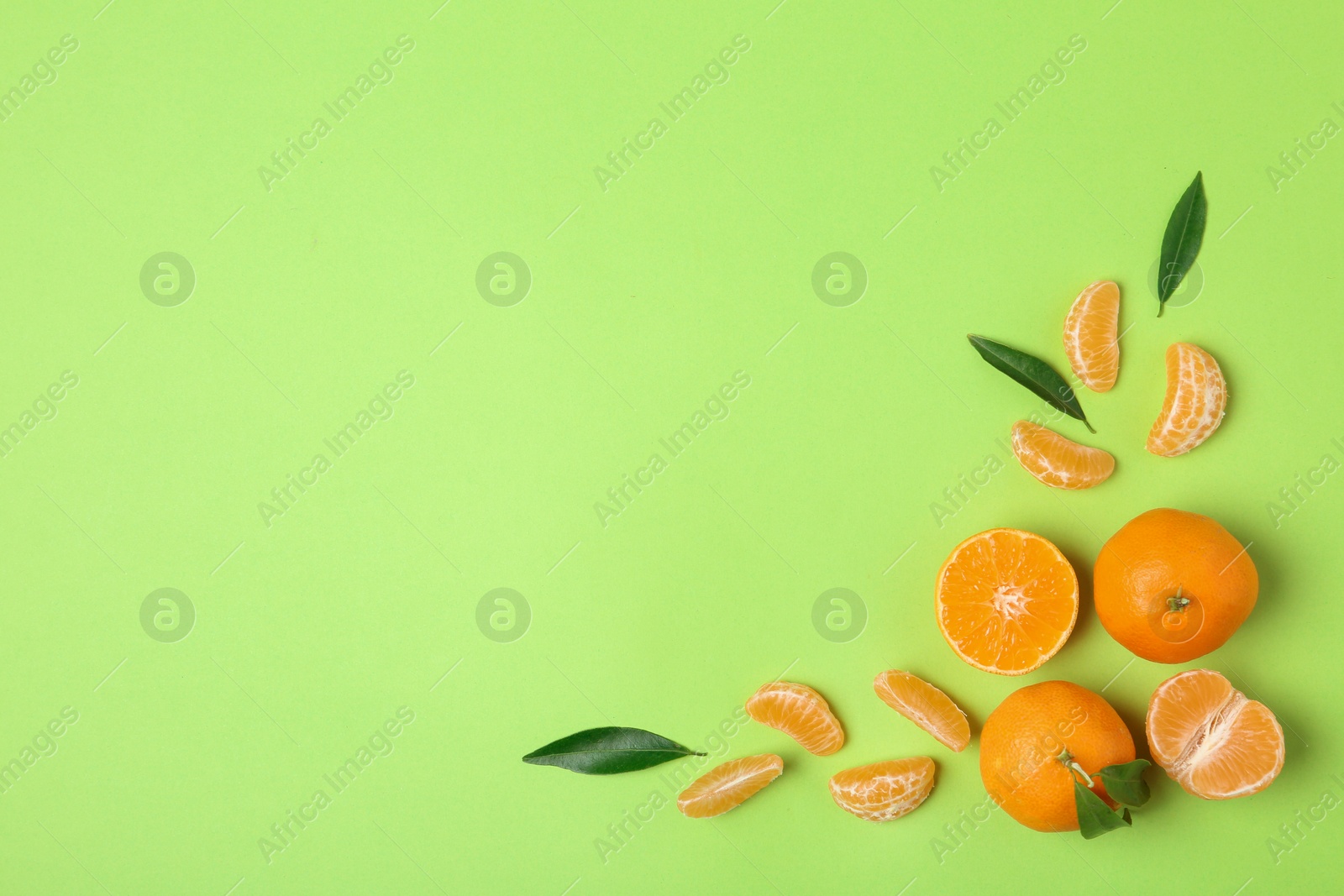 Photo of Composition with tangerines and leaves on color background, flat lay. Space for text