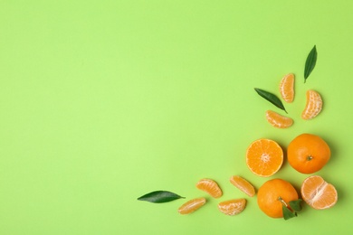 Photo of Composition with tangerines and leaves on color background, flat lay. Space for text