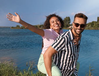 Photo of Couple having fun near river at summer party