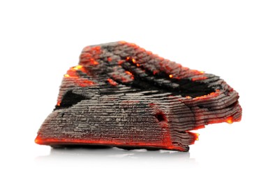 Photo of Piece of smoldering coal on white background