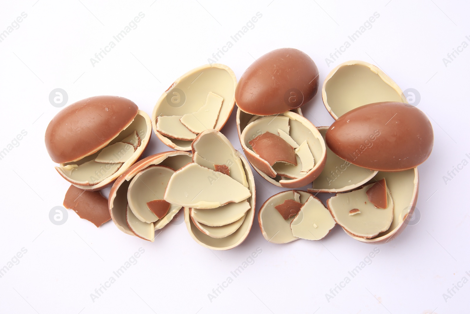 Photo of Sveti Vlas, Bulgaria - July 3, 2023: Broken halves of Kinder Surprise Eggs isolated on white, top view