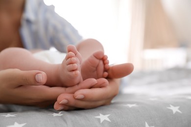 Mother and her little baby on bed, closeup