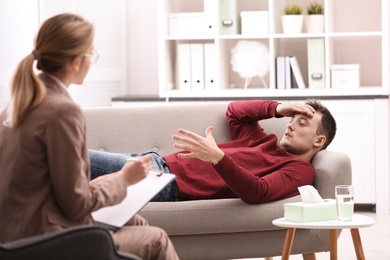 Psychotherapist working with young man in office