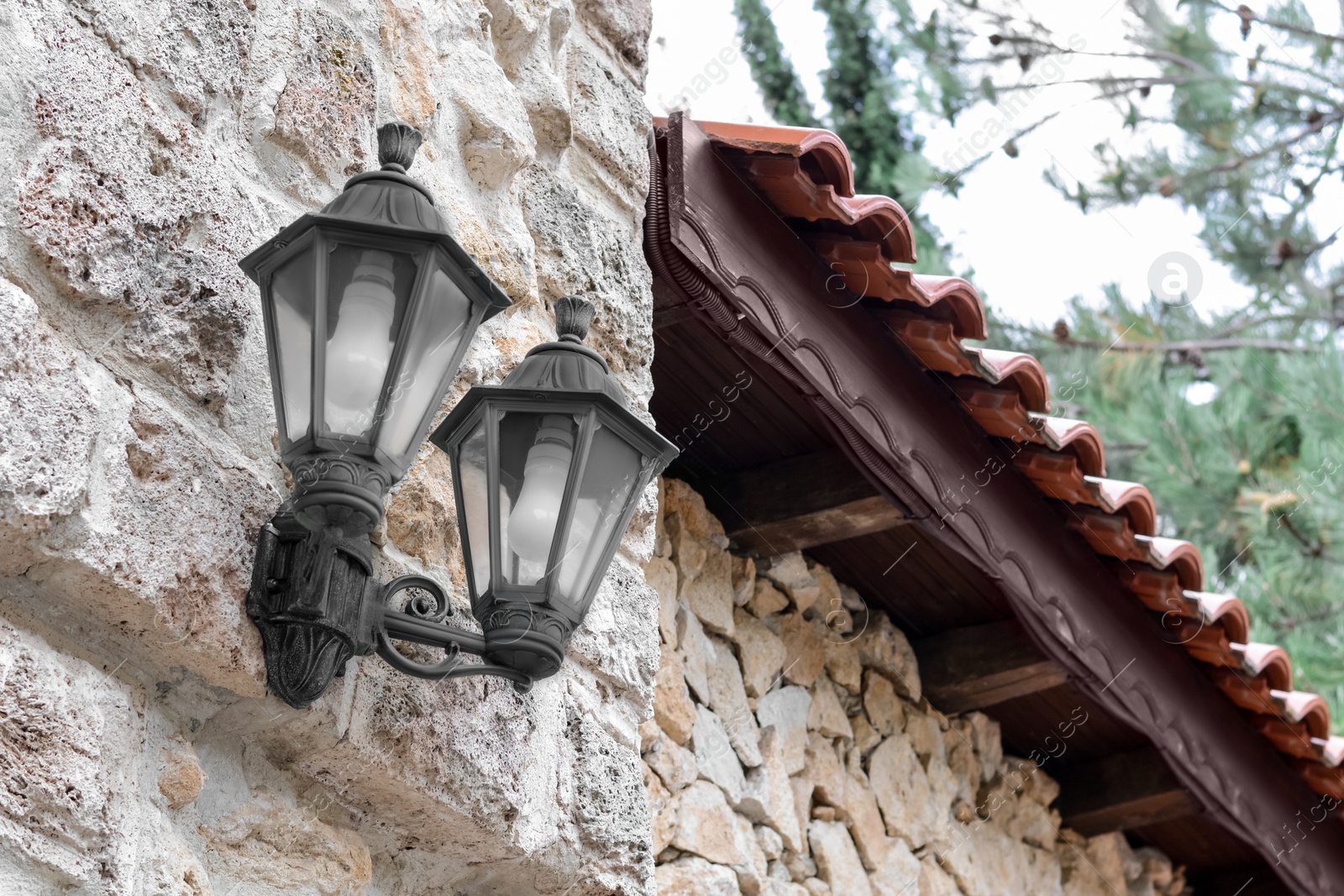 Photo of Beautiful old fashioned street lamps on wall of building
