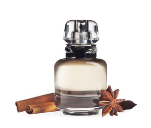 Photo of Bottleperfume and different spices on white background