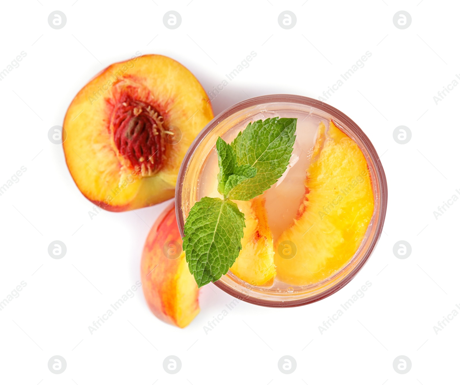 Photo of Peach cocktail in glass and fresh fruit on white background, top view