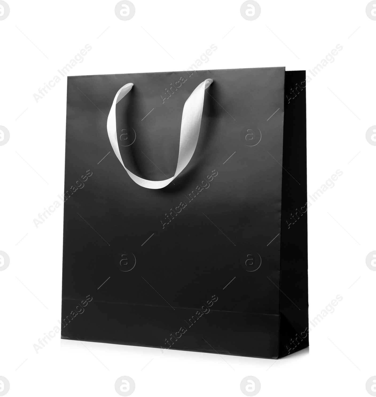 Photo of Paper shopping bag with ribbon handles on white background. Mockup for design