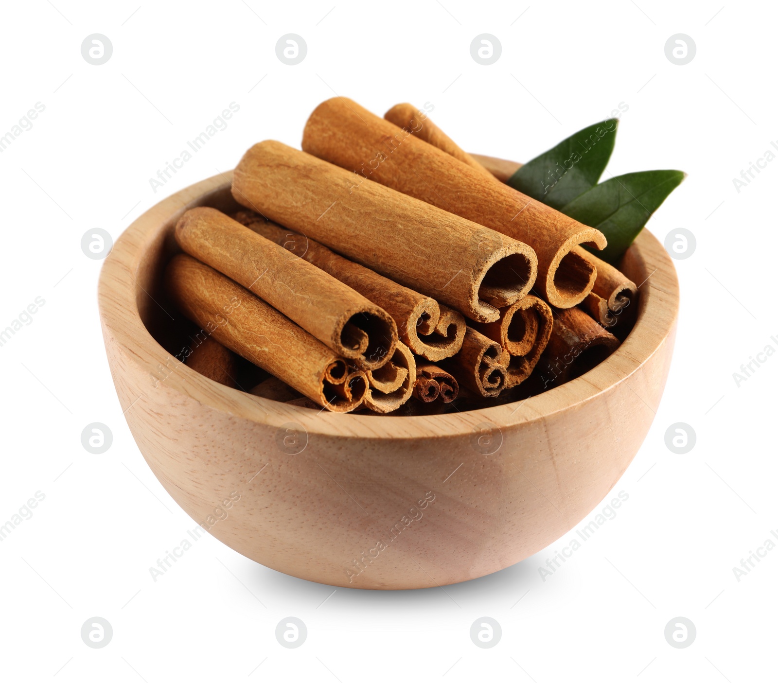 Photo of Cinnamon sticks and green leaves in bowl isolated on white