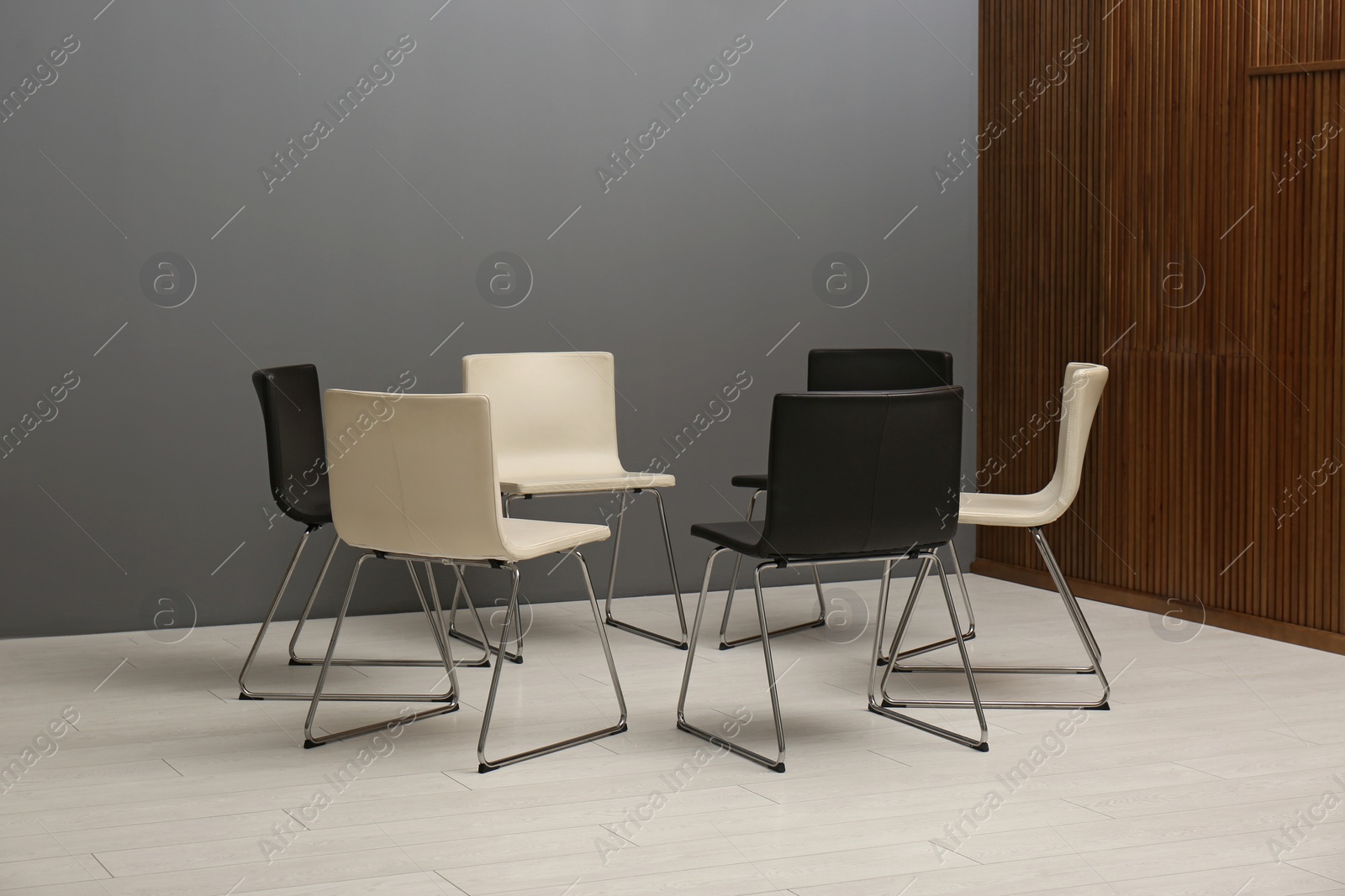 Photo of Chairs prepared for group therapy session in office. Meeting room interior