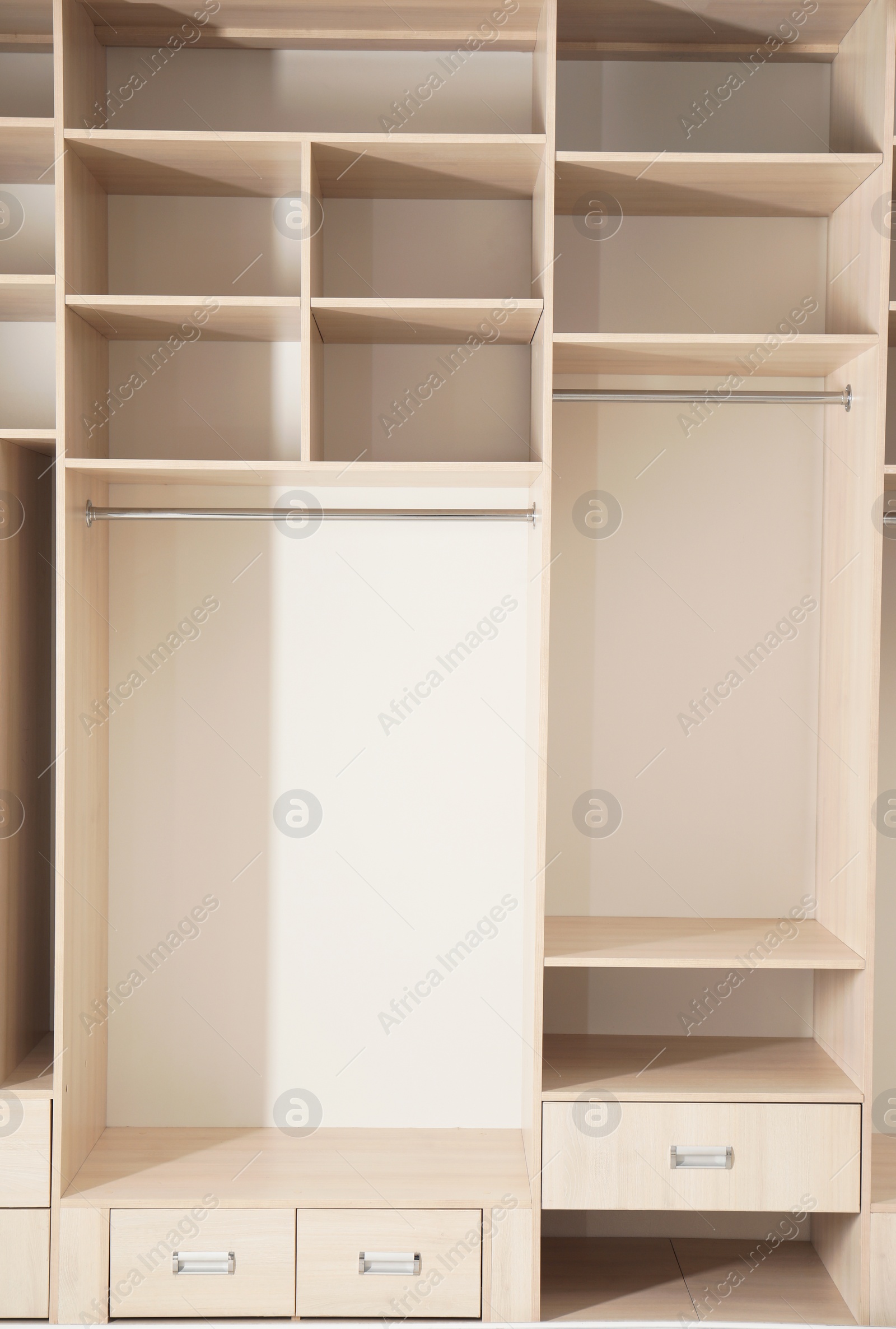 Photo of Empty wooden wardrobe with shelves and drawers as background