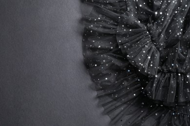 Photo of Beautiful black tulle fabric on grey background, top view. Space for text