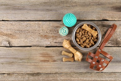 Photo of Different pet goods on wooden table, flat lay and space for text. Shop assortment