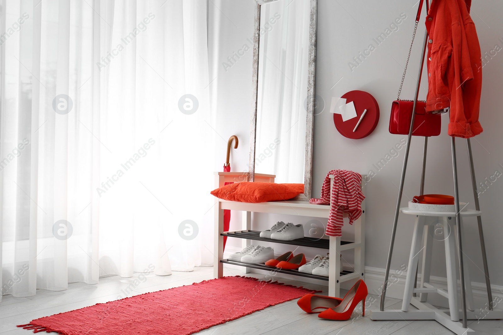 Cozy stylish hallway interior with shoe rack and mirror, space for text. Home design idea Photo of Cozy stylish hallway interior with shoe rack and mirror, space for text. Home design idea