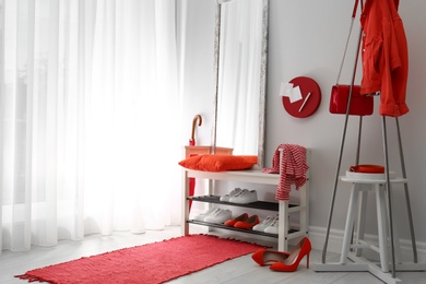 Photo of Cozy stylish hallway interior with shoe rack and mirror, space for text. Home design idea
