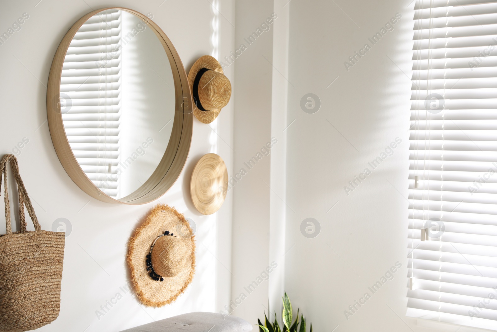 Photo of Stylish round mirror hanging on white wall in room