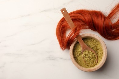 Photo of Bowl of henna powder and red strand on white marble table, flat lay with space for text. Natural hair coloring