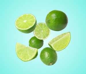 Image of Fresh lime fruits falling on light blue background