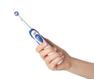 Woman holding electric toothbrush against white background