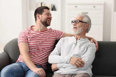 Happy son and his dad spending time together at home