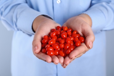 Photo of Woman holding fresh goji berries, closeup view