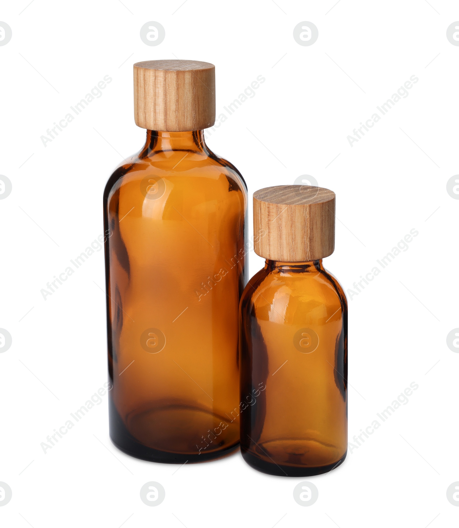 Photo of New empty glass bottles with wooden caps isolated on white