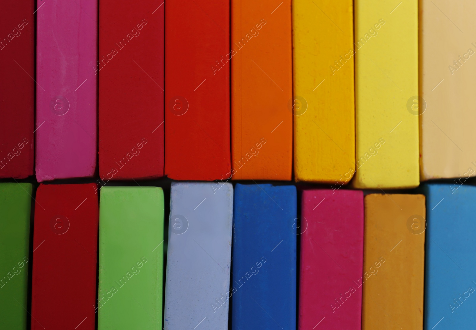 Photo of Set of colorful pastels as background, closeup. Drawing materials