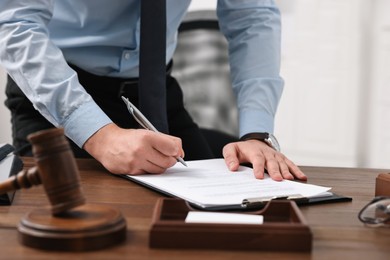 Photo of Lawyer working at wooden table in office, closeup