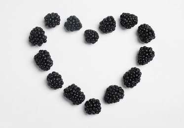 Flat lay composition with ripe blackberries on white background