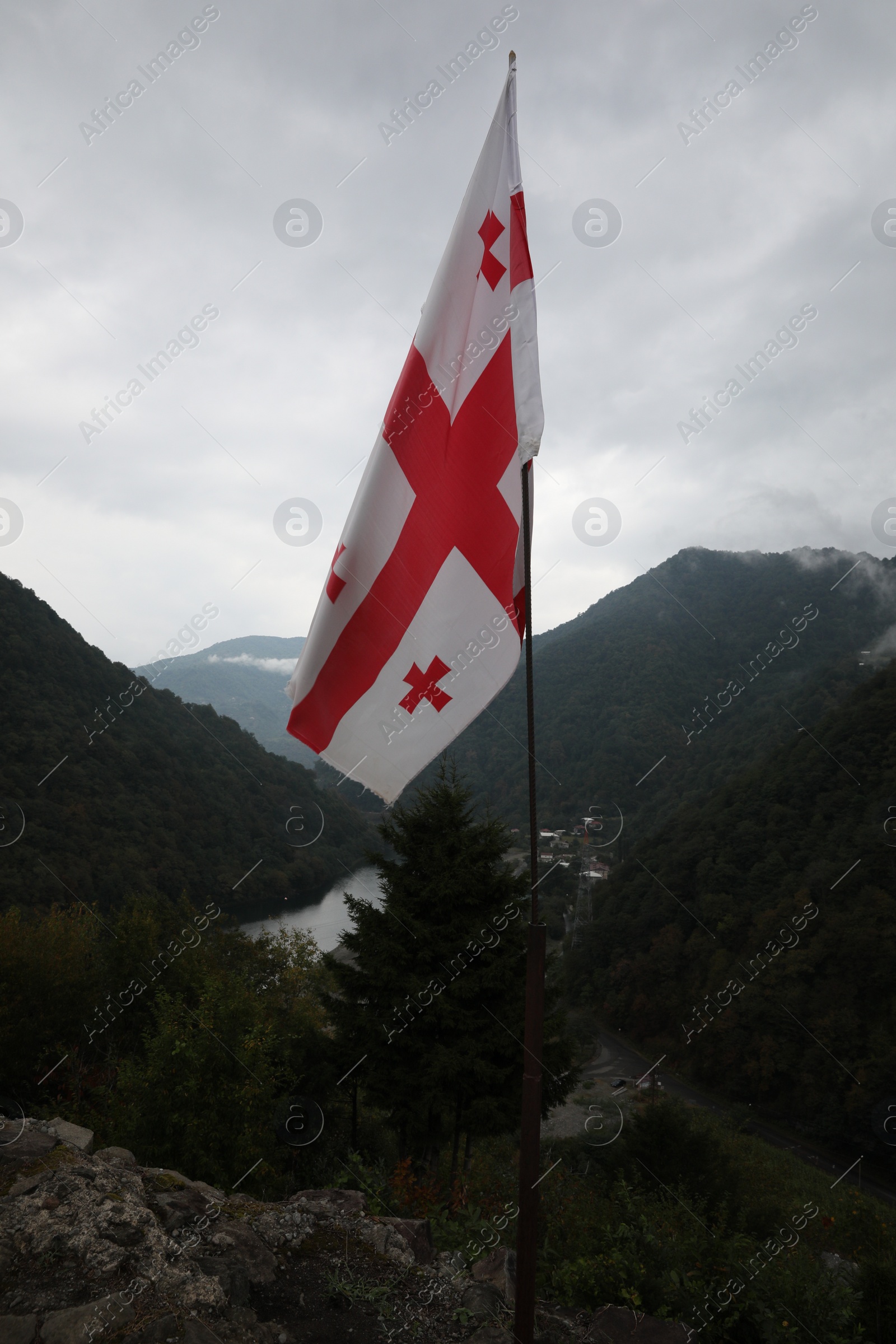 Photo of Adjara, Georgia – September 4, 2002: Georgian flag on Gvara Fortress in mountains