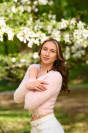 Photo of Beautiful young woman near blossoming tree on spring day