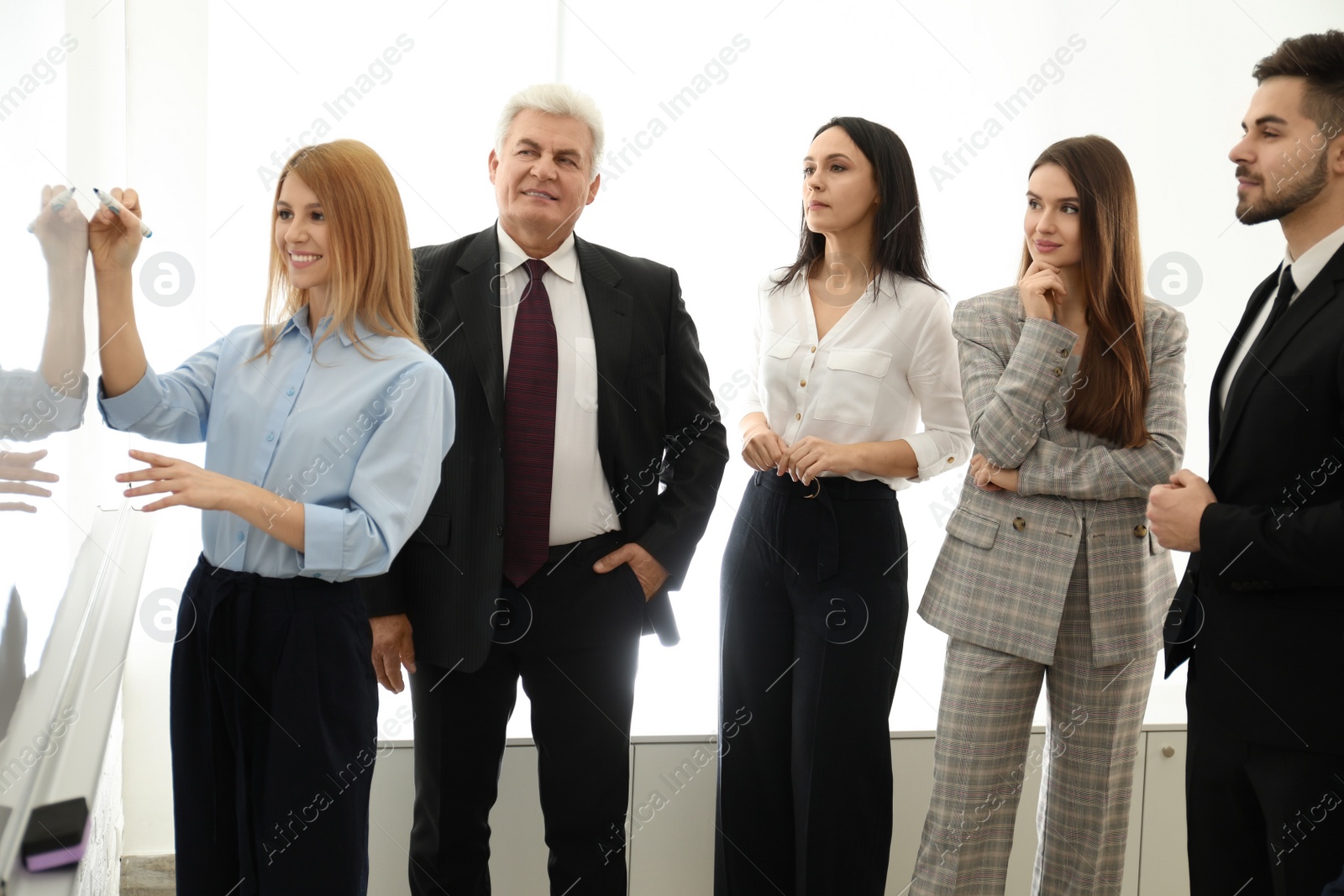 Photo of Professional business trainer working with people in office