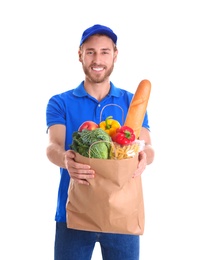 Photo of Delivery man holding paper bag with food products on white background