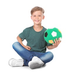 Playful little child with soccer ball on white background. Indoor entertainment